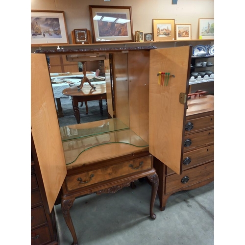 334 - An early 20th century walnut veneered cocktail cabinet. COLLECT ONLY.