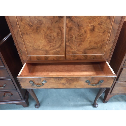 334 - An early 20th century walnut veneered cocktail cabinet. COLLECT ONLY.