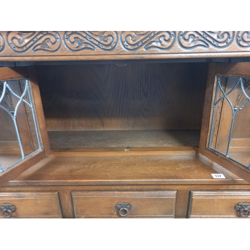 337 - A 1930's solid oak buffet with lead glazed doors. COLLECT ONLY.