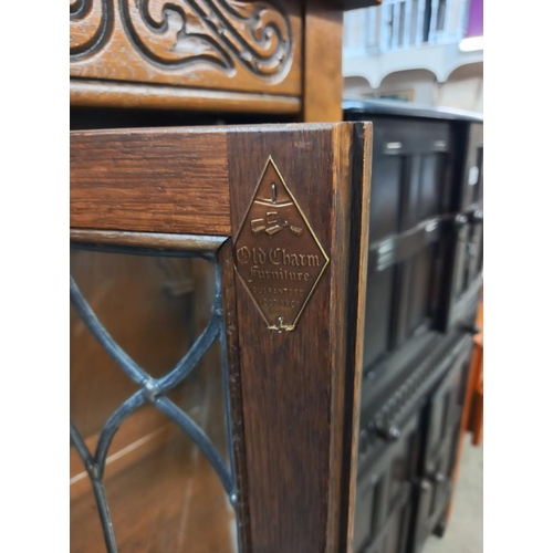 337 - A 1930's solid oak buffet with lead glazed doors. COLLECT ONLY.