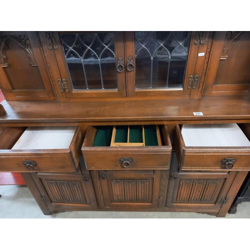 337 - A 1930's solid oak buffet with lead glazed doors. COLLECT ONLY.