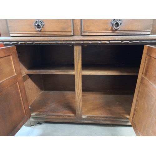 337 - A 1930's solid oak buffet with lead glazed doors. COLLECT ONLY.