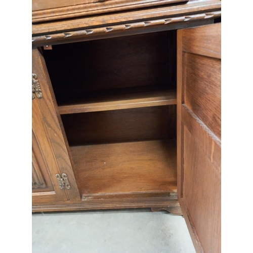 337 - A 1930's solid oak buffet with lead glazed doors. COLLECT ONLY.