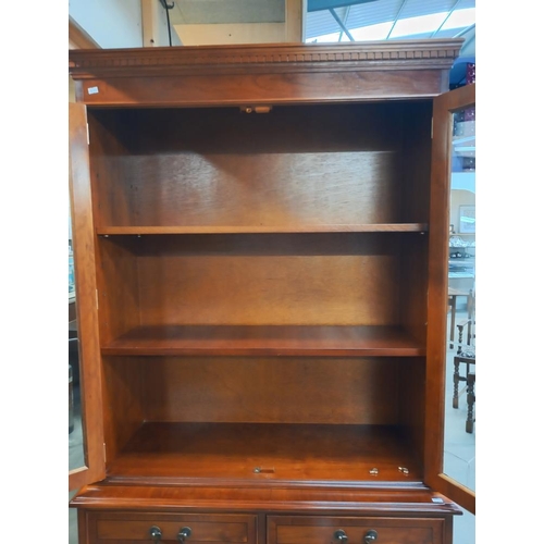 352 - A darkwood stained bookcase/display cabinet with cupboard. COLLECT ONLY.