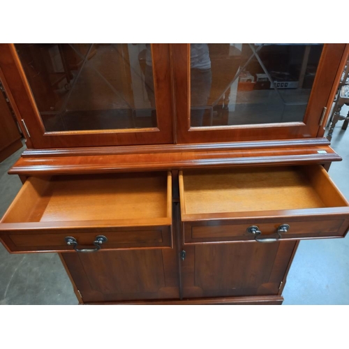 352 - A darkwood stained bookcase/display cabinet with cupboard. COLLECT ONLY.