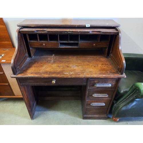 389 - A Victorian oak single pedestal roll top desk. COLLECT ONLY.