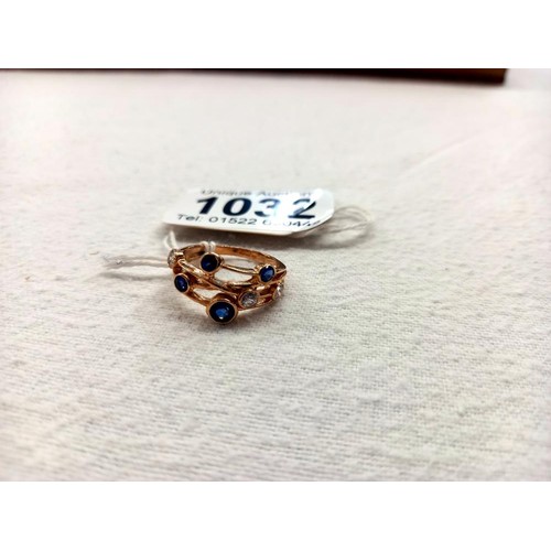 1032 - A Boodles style sapphire and diamond ring in yellow gold, size N, 3.2 grams.