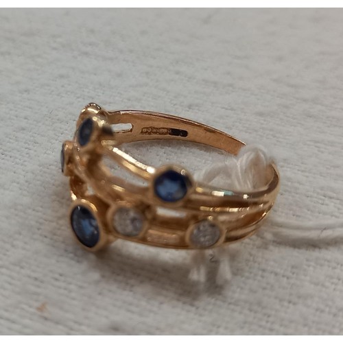 1032 - A Boodles style sapphire and diamond ring in yellow gold, size N, 3.2 grams.