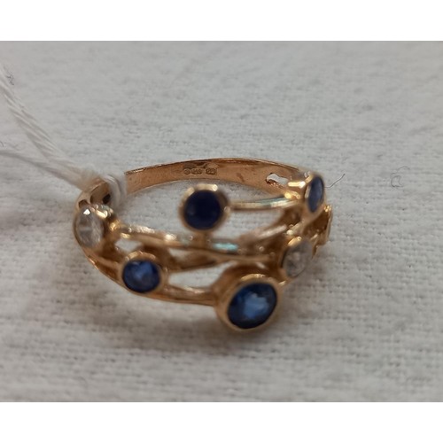 1032 - A Boodles style sapphire and diamond ring in yellow gold, size N, 3.2 grams.