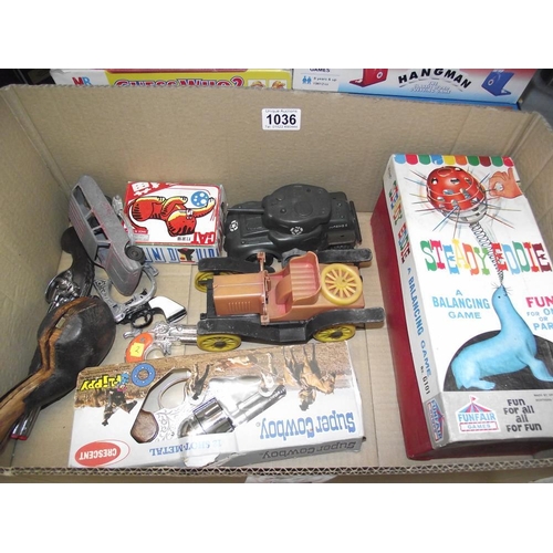 1036 - A box of mixed toys including Tri-ang Minic tank, clockwork tinplate cat, Crescent super cowboy cap ... 