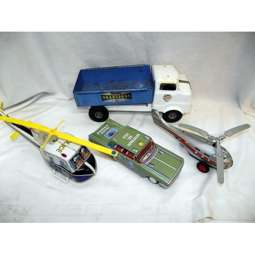 1046 - A tinplate battery operated helicopter and one other, clockwork police car, boxed train, roadway set... 