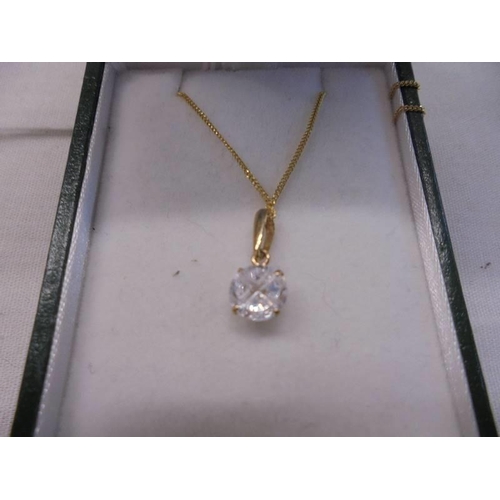 1008 - A 9ct gold pendant set white stone on a 9ct gold chain, 1 gram.