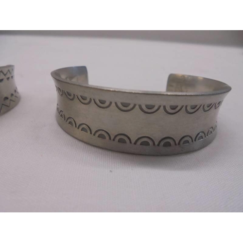 1011 - Three Jorgen Jensen pewter cuffs (Nos 150, 168 and 185).