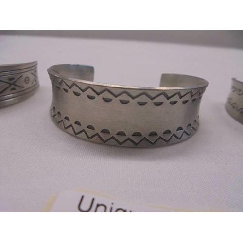 1011 - Three Jorgen Jensen pewter cuffs (Nos 150, 168 and 185).