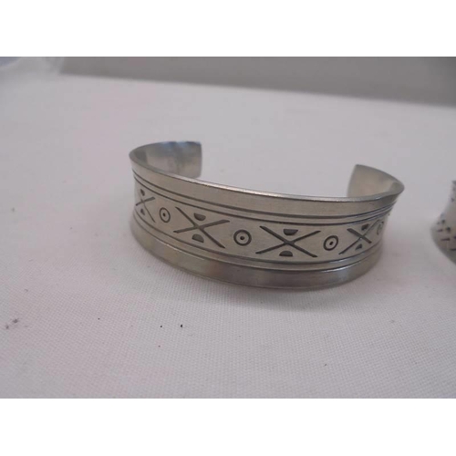 1011 - Three Jorgen Jensen pewter cuffs (Nos 150, 168 and 185).