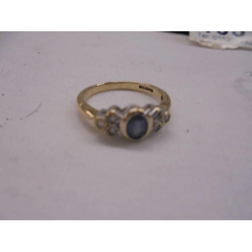 1031 - A 9ct gold oval sapphire with three diamonds ring, size L, 2.3 grams.