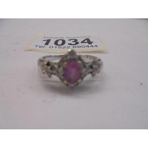 1034 - An 18ct white gold pink sapphire and diamond ring, size N, 3.6 grams.