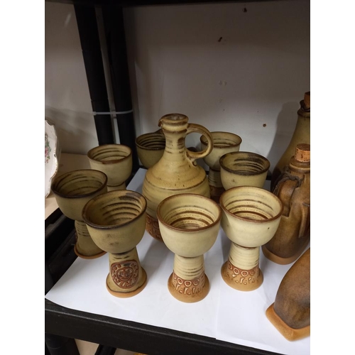 1251 - A stoneware studio pottery coffee set with brandy, rum and wine containers COLLECT ONLY