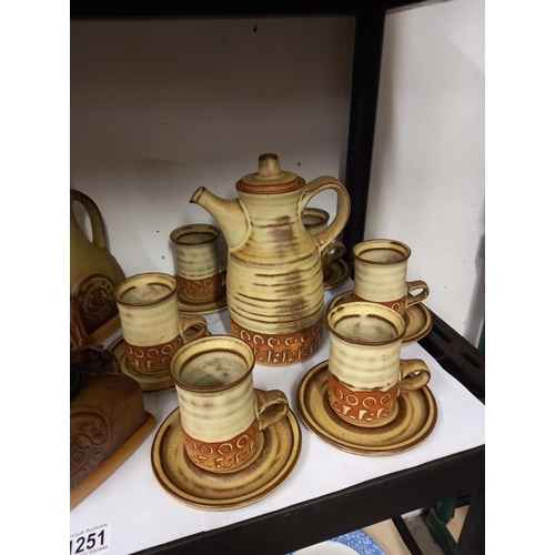 1251 - A stoneware studio pottery coffee set with brandy, rum and wine containers COLLECT ONLY