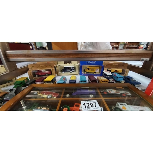 1297 - A quantity of Lledo models etc, some with boxes and some in a display cabinet COLLECT ONLY