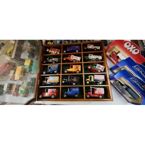 1297 - A quantity of Lledo models etc, some with boxes and some in a display cabinet COLLECT ONLY