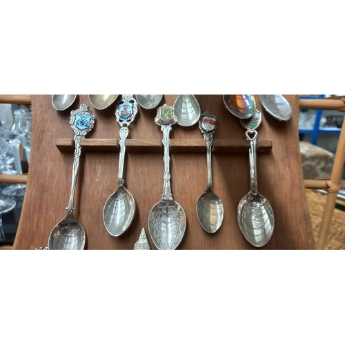 1585 - A display of tourist collectors spoons including silver and enamelled examples