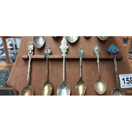 1585 - A display of tourist collectors spoons including silver and enamelled examples