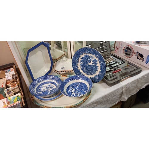 1696 - A quantity of dinnerware including Blue Willow COLLECT ONLY