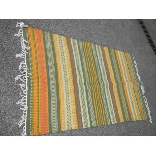 533 - A good green patterned rug, 39 x 66 inches. COLLECT ONLY.