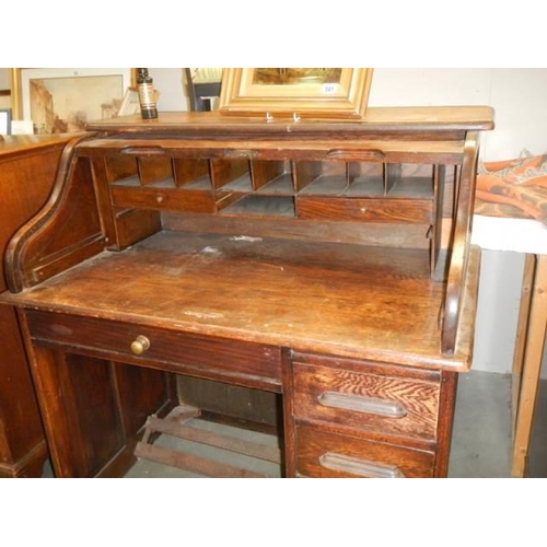 540 - An early 20th century single pedestal roll top desk in fair condition, COLLECT ONLY.