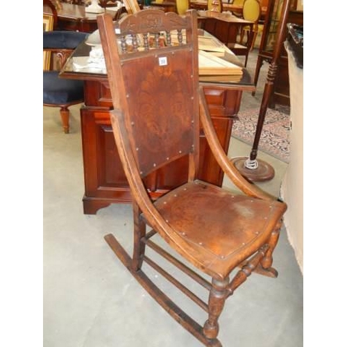 550 - A late Victorian oak rocking chair with poker work seat and back, COLLECT ONLY.