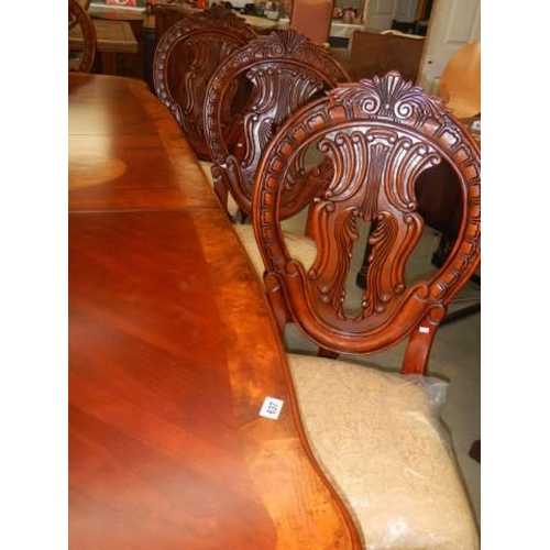 637 - A mahogany extending dining table with an extra lead and a set of 8 dining chairs, COLLECT ONLY.