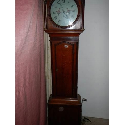 699 - A 30 hour oak cased Grandfather clock with painted dial, cross banded inlay, complete and ticking bu... 