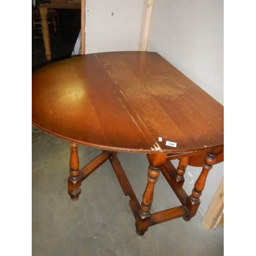 706 - An oval oak gate leg table with barley twist supports, COLLECT ONLY.