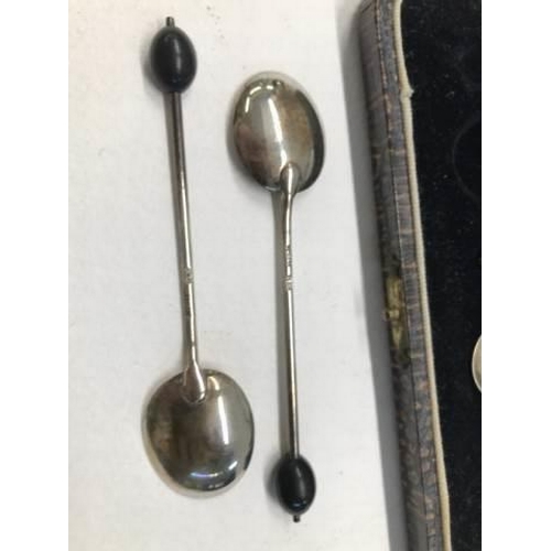 1075 - A cased set of six coffee bean spoons.