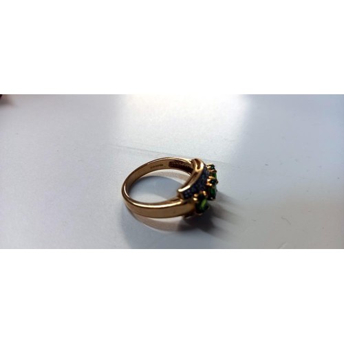 1060D - A 9ct gold rung with emeralds and diamonds, size N