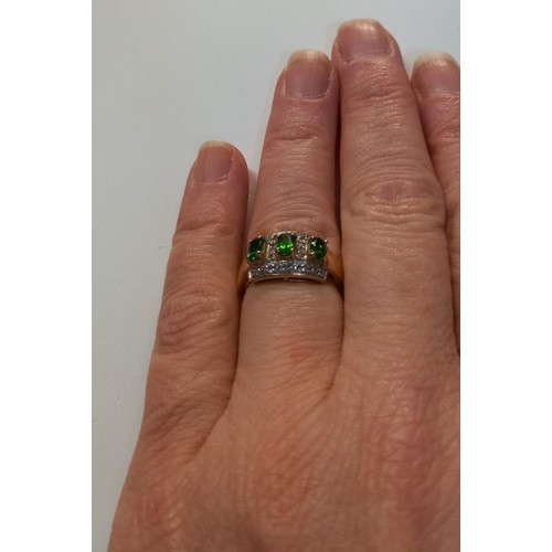 1060D - A 9ct gold rung with emeralds and diamonds, size N