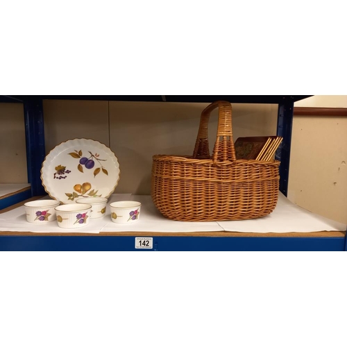 142 - A wicker basket with glass and silver plate coasters plus placemats and Royal Worcester Evesham ware... 