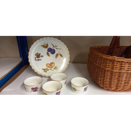 142 - A wicker basket with glass and silver plate coasters plus placemats and Royal Worcester Evesham ware... 