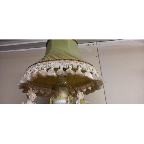 61 - A green bisque porcelain figural table lamp. COLLECT ONLY