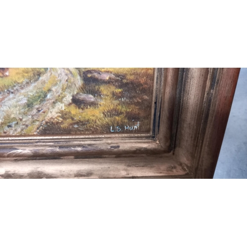 153 - A vintage gilt framed overpainted print of Highland cattle in the shadow of mountains signed l.B Hun... 