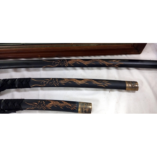 166 - A 3 piece replica Samurai sword set with matt black finish engraved dragon motifs and head Pommel (K... 