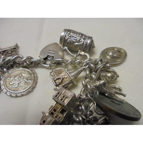 1001 - A four ounce silver charm bracelet.