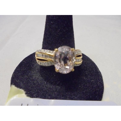 1002 - A 9ct yellow gold ring set centre topaz surrounded by diamonds, size O, 4 grams.