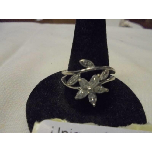 1007 - An 18ct white gold diamond set floral ring, size O, 5.1 grams.