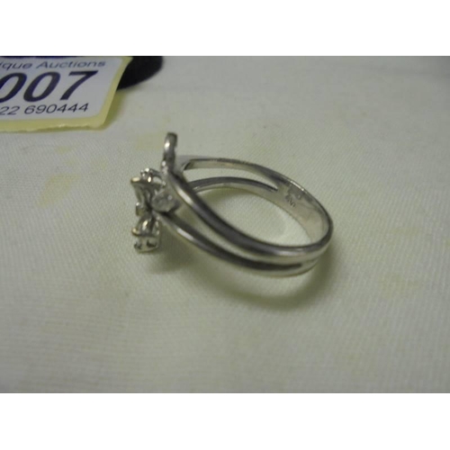 1007 - An 18ct white gold diamond set floral ring, size O, 5.1 grams.