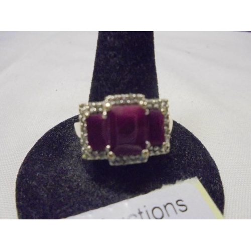 1008 - A three section ruby and diamond ring in 9ct gold, size O half, 4.4 grams.