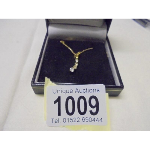 1009 - A diamond pendant set brilliants and two yellow diamonds on 9ct gold chain, 1.6 grams.