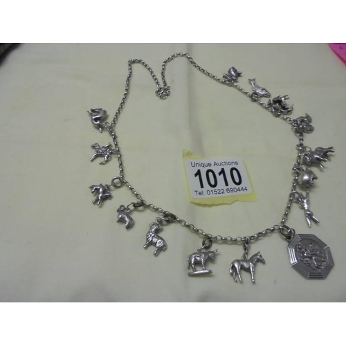 1010 - A long silver chain with forteen animal related charms,