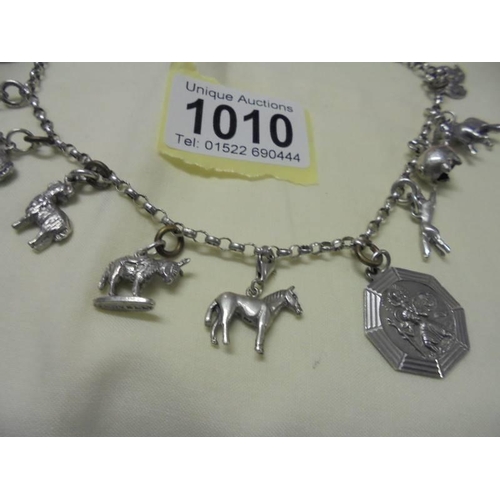 1010 - A long silver chain with forteen animal related charms,